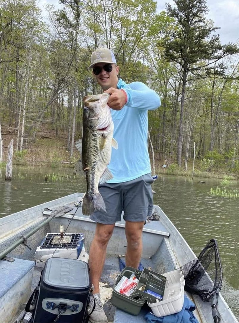 Angler holding a large largemouth bass