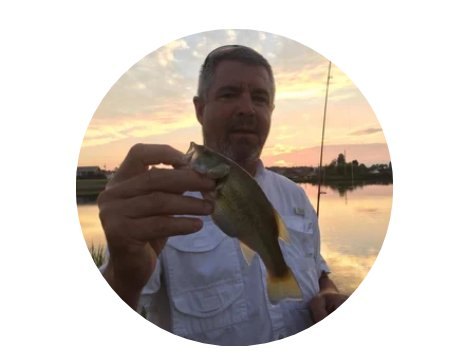 Angler holding a bass at sunset
