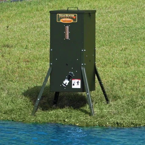 Texas Hunter automatic fish feeder set up at the water's edge