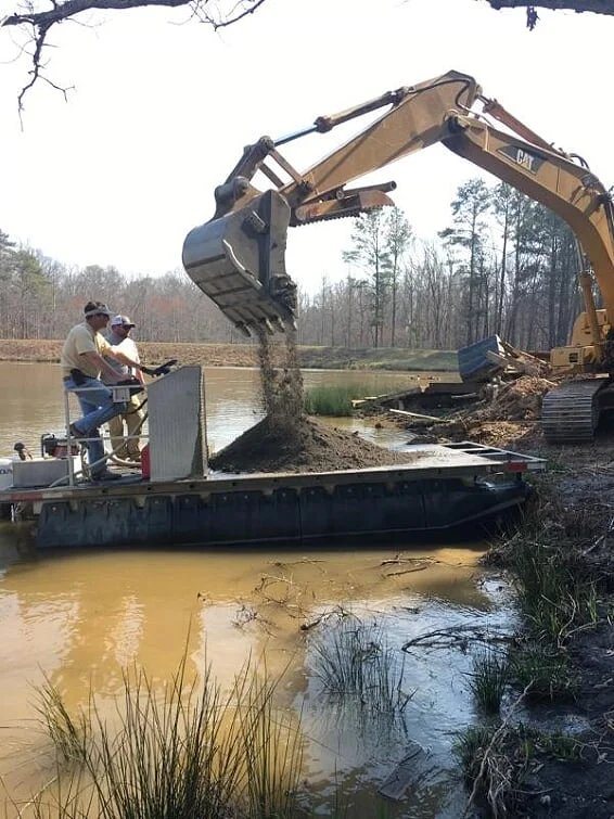 Excavator and work barge enhancing pond habitat